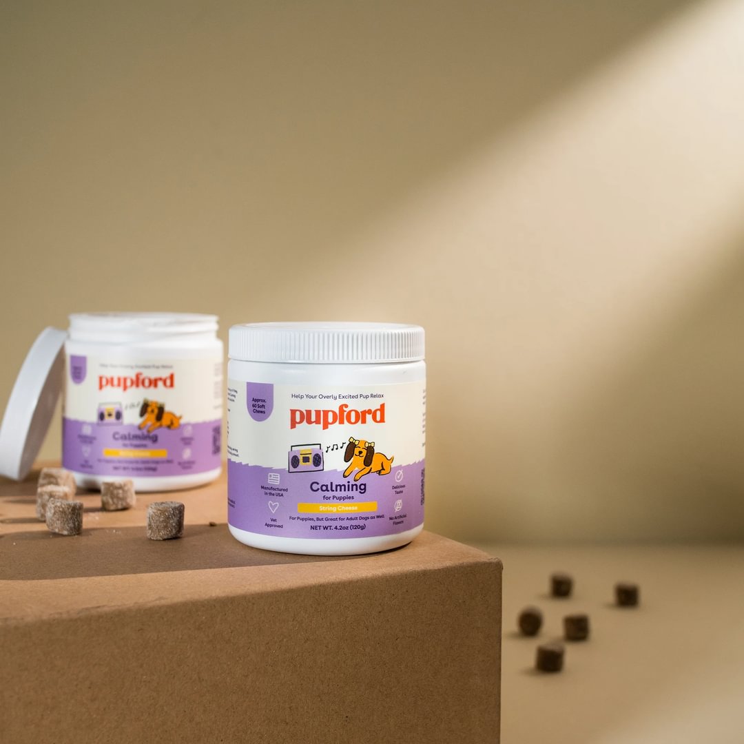 2 tubs of calming supplements with the chews out on the table | Pupford