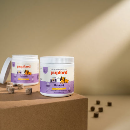2 tubs of calming supplements with the chews out on the table | Pupford