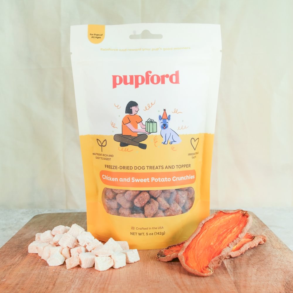 chicken and sweet potatoes in front of a bag of crunchies treats | Pupford