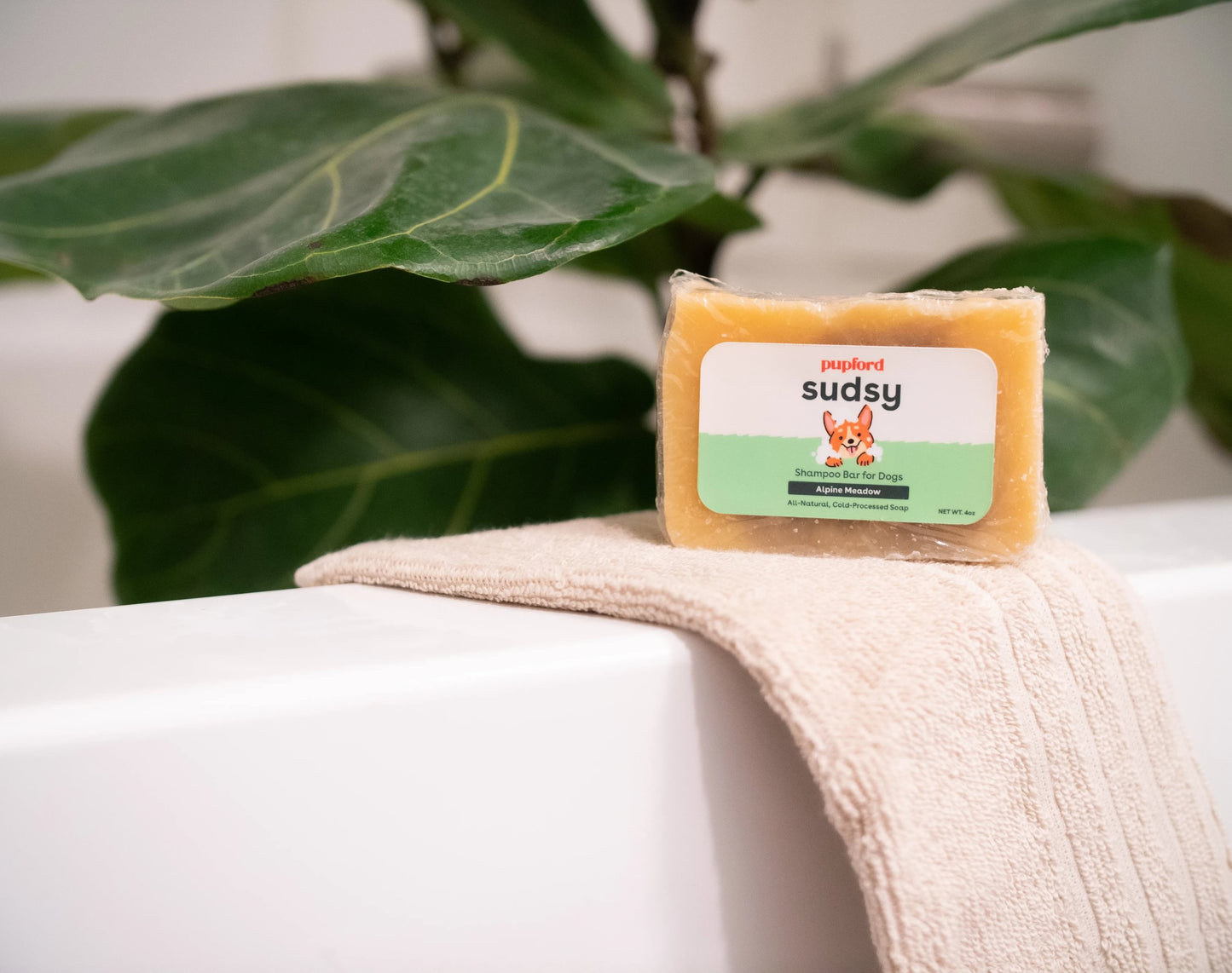 sudsy shampoo bar alpine meadow on the edge of a tub on a towel | Pupford